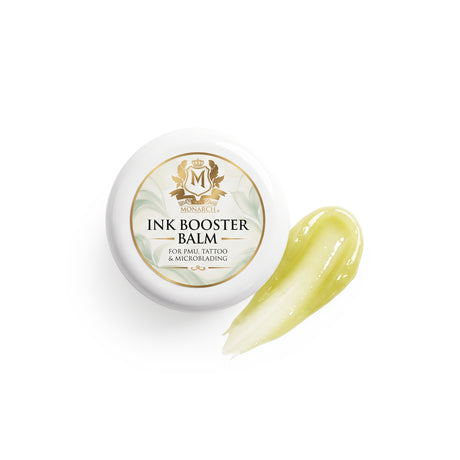 Skin Monarch Ink Booster Balm 30ml, dangtelis šalia blizgaus geltono balzamo potėpio