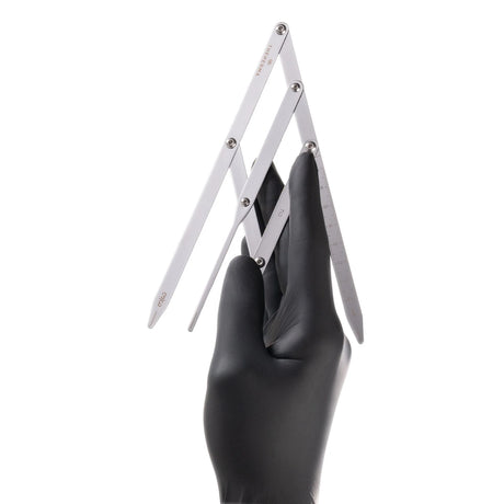The Perma Golden Ratio Divider Brow Compass used for precise eyebrow shaping and measurement with branded design.