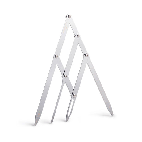 The Perma Golden Ratio Divider Brow Compass shown with metal arms and measurement markings for precise eyebrow shaping.