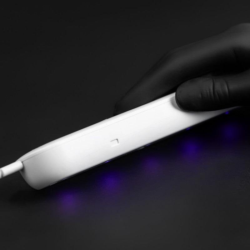 UV sterilizer for tattoo machines by BVShop, compact device with clear lid and control buttons for sterilizing tattoo equipment.